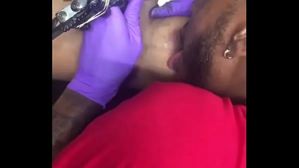 XXX Horny tattoo artist multi-tasking sucking client's nipples top Clips